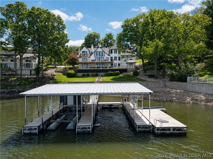 A remodeled masterpiece! This extraordinary waterfront home has been taken down to the studs and completely reimagined with new LP smart siding, windows/doors, HVAC units, flooring, and drywall. Finished with custom steel railings, built in bunk bunks, designer lighting, and spa like bathrooms. On the main and lower levels, two sets of ~12 ft custom slider doors showcase the impeccable main channel views. Situated directly across from Four Seasons for a front row seat to the lakes best fireworks display. Enjoy the gentle sloping double lot with your own private beach and room for a pool. Furniture included and NO HOA (short term rentals are allowed). To complete the package, a three-car garage and expansive circle driveway with ample parking. This is luxury living at its finest - built to impress!