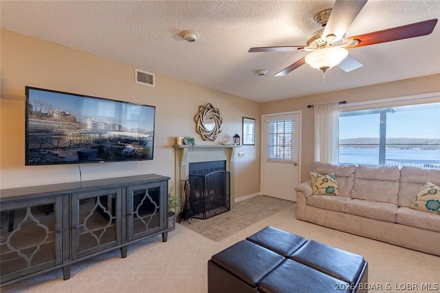 Main channel views, vacation rental eligibility, and a covered boat slip make this 2-bed, 2-bath lakefront condo at Breakwater Bay Club a standout at Lake of the Ozarks. Located at the 22-mile marker in Osage Beach, this well-maintained unit offers 1,125 sq ft, direct lake access, and stunning open water views. Pride of ownership is evident throughout, with a nicely updated primary bathroom and a clean, move-in-ready feel. The screened-in deck expands your living space outdoors, giving you a front-row seat to lake activity while keeping the bugs out. Easy access with just a few steps from covered parking to the front door adds to the appeal. The 10x28 covered slip with 8,000 lb lift sits just steps from the unit, ideal for a pontoon or deck boat. A new dock is coming in May with a larger 12x32 slip (A1). Breakwater Bay Club amenities include a pool, clubhouse, playground, and tennis courts. Nightly rentals allowed—perfect for investment or personal use!