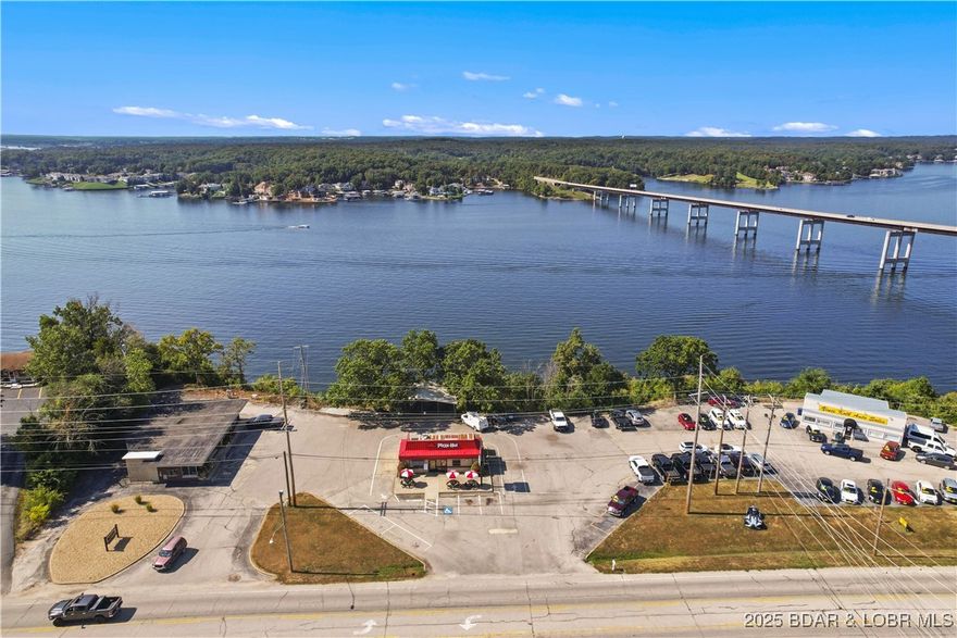 In a commercial setting this has to be one of the best views the Lake of the Ozarks has to offer.  This piece of real estate has been held by the same family for over 85 years and now it is finally available.  So much opportunity!  Approximately 3 acres of commercially zoned lakefront with spectacular views on Bagnell Dam Blvd in the heart of Lake Ozark.  Currently there are three operating businesses that lease the property with each paying rent.  The large flat spot where the buildings are located offers great potential but beyond that developers have considered constructing buildings that partially hang over the bluff and could even provide access down to the 660 feet of shoreline.  There is also five acres across Bagnell Dam Boulevard that could be available to be sold for additional money if needed for a proposed development.  However this ground is leased for several more years to the go kart tract.  High traffic, amazing views, easy access and a great commercial location, what else could you ask for?  There is also the possibility of bringing in fill to make a larger pad site on the side of the property closest to JB Hooks.