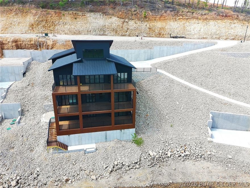 BRAND NEW CUSTOM HOME located on the 3 Mile Marker of Horseshoe Bend!! This stunning, modern style build captivates all the aspects of lake life. This home boasts 5 spacious bedrooms, 7 beautifully designed bathrooms, a state-of-the-art kitchen, and a custom Wet bar/ entertainment area! This home has cove protection along the waterfront to allow for plenty of fun Lakeside, but still offers tremendous main channel views of the Lake of the Ozarks. This highly customized home will be located just minutes from the Heart of Osage beach, Four Seasons golf courses, and a plethora of great restaurants on the Lake. A brand new dock is available for purchase for $135,000.