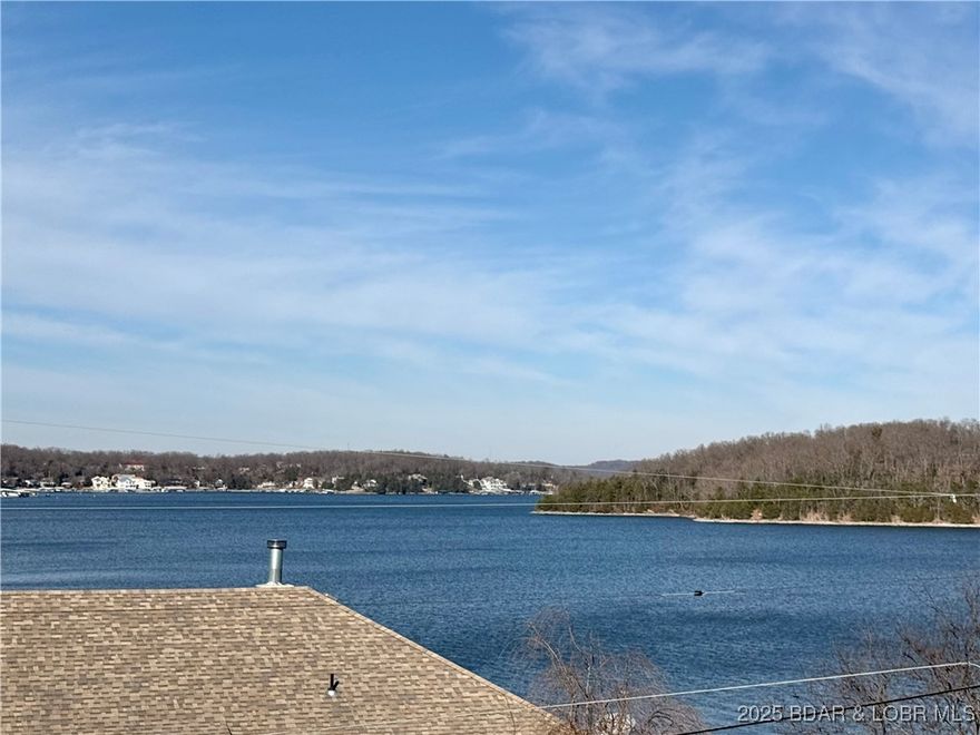 Million dollar views! This beautifully updated home features 3 bedrooms, 2 baths, living room with wood floors, open spacious dining area with electric fireplace, large kitchen with gas range and pantry, family room with wet bar, large sunroom, and 3 seasons room. Over 950 sq ft of decks for outdoor entertaining and to enjoy the amazing view of the lake. Updates in past 4 years include 30x30 garage, fenced backyard, landscaping, Prodigy vinyl siding, soffit, facia, HVAC, water heater, both bathrooms, LVP flooring, Plumbing, wet bar, decks, interior paint & small 3 season room. Gated community, community boat ramp & common area. Plenty of parking in front of home in driveway and 5-6 spots in rear of home, plus the detached garage that is large enough to store your fishing boat. Call today to schedule your private showing of the amazing home.