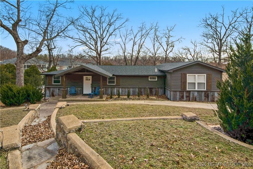 Fully renovated lake home in a prime Lake Ozark location at the 8MM, tucked into a protected deep-water cove with 100’ of shoreline—perfect for swimming, boating, and relaxing lakeside. This spacious 5BR, 3BA home sits on a gentle oversized lot with minimal steps and offers mostly one-level living, plus a bonus room/5th bedroom in the walkout basement. The home was completely redesigned and expanded with a two-bedroom addition, vaulted ceilings, & an open layout that fills the space with natural light. Every major system has been replaced or updated including electric (run underground), plumbing, septic, roof, exterior, decks, windows, HVAC, drywall, flooring, cabinetry, appliances, and baths—finished with leathered granite countertops. Plenty of sleeping space and parking for 10+ vehicles make this ideal as a full-time residence, second home, or income-producing vacation rental. Current owners have enjoyed strong rental performance. Large lot offers room to enhance outdoor living and create your own lakefront retreat. Centrally located, well protected, and turn-key ready—this Lake Ozark gem delivers lifestyle, income potential, and value in one package all located on beautiful HH!
