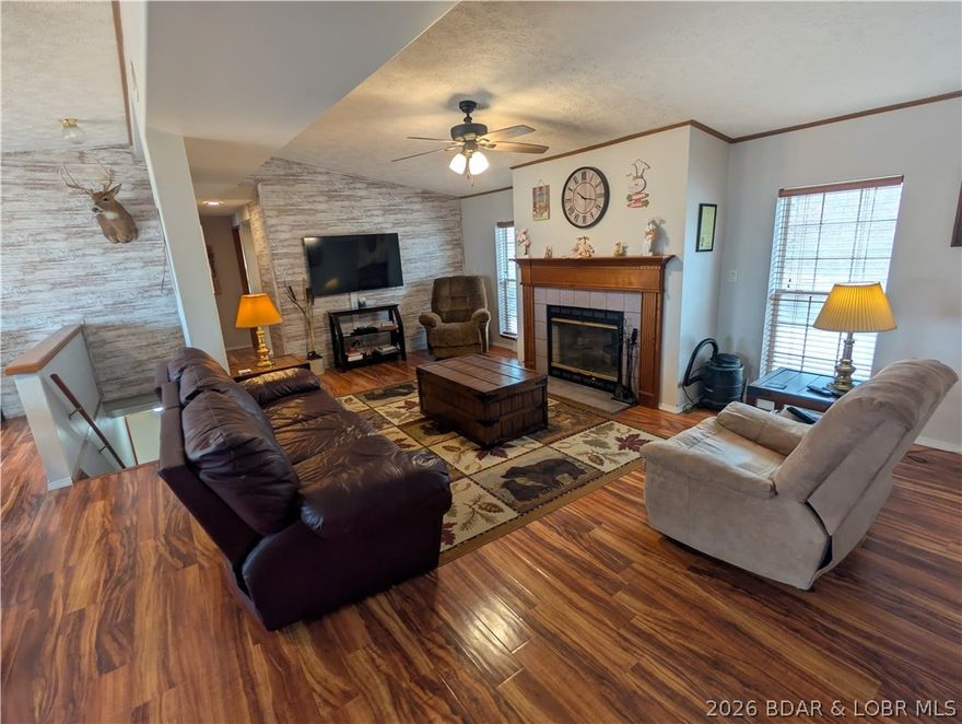 **Remodeled 2026 and Beautiful** Welcome to this spacious 3-bedroom, 3-bath home with stunning main channel views from the upper deck level! Nestled in a cozy neighborhood at the 3-mile marker of the Gravois Arm, this property offers convenience to everything Laurie has to offer – including the Fire District, restaurants, shopping, and doctors’ offices along Highway 5. Inside, you’ll find main-level living and two bonus rooms on the lower level with new flooring, drywall added, and tastefully painted. The lower level is perfect for an office, den, reading room, workout space, or extra guest quarters (non-compliant). The home features a dual HVAC system for year-round comfort, a cozy fireplace, and a leased water softener and reverse osmosis systems for your convenience. Enjoy relaxing or entertaining on the deck while taking in beautiful lake views. Don’t miss this opportunity to live the lake life at its finest!