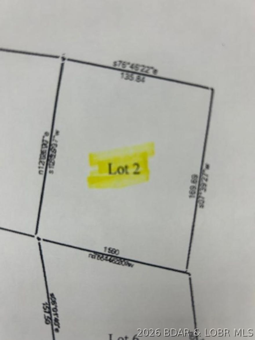 Gentle lake access lot located on a black top road in Johnsons Bay. Lot 2 is very suitable for a 1 level home. This area is served by a central water and sewer system from Central States Water Resources. Currently the monthly cost of water is $27, and sewer is $47.50, hookup fee for these systems is TBD. There is a common lakefront area near the community dock that has a boat ramp for your lake access. This area contain moderate to high end homes.  Take a look, multiple lots available individually or as a package of 4.