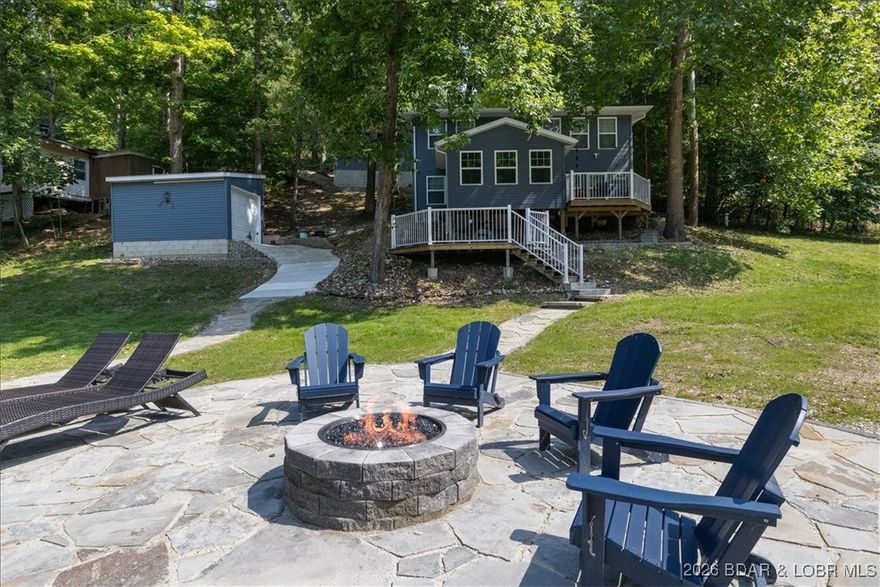 Summer is sweet at Rock Hollow Retreat! This completely remodeled lakefront home is tucked into a peaceful no-wake cove—ideal for swimming, floating, and relaxing without boat traffic. Enjoy lake life with your private dock featuring a 10x24 boat slip, swim ladder, sun deck, and a lakeside fire pit for evening gatherings.

Inside, the open-concept kitchen shines with granite countertops, a large breakfast bar, and ample seating—perfect for entertaining. The adjoining dining area comfortably seats a crowd, while two spacious living areas (one on each level) offer cozy seating, flat-screen TVs, and beautiful lake views.

The main-level primary suite features a king bed and spa-like bath with double vanity and walk-in tile shower. The lower level includes three additional bedrooms—two kings and two queens—providing space for family and guests.

Outside, relax on the expansive deck, gather around the fire pit, or head out on the water from your private dock. Located just 6 minutes from The Cave Bar & Grill, minutes from Osage Beach,  Whether as a full-time home, lake getaway, or vacation rental investment, this property delivers the perfect Lake of the Ozarks experience.