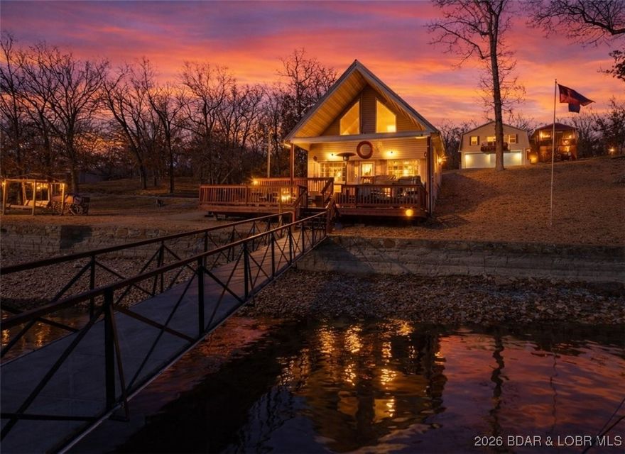 The classic A-frame everyone loves—paired with the kind of lake lot everyone wants! Located at the 60MM in Rainy Creek Cove, this 3-bedroom, 2-bath lakefront retreat delivers breath-taking views, calm waters from cove protection, and a rare zero-step option walk to the dock. Whether you’re creating lifelong lake memories or looking for a nightly investment opportunity, this property offers a little bit of everything. Inside, vaulted ceilings and big windows bring in natural light and showcase the lake views, while the oversized kitchen with custom cabinetry and tons of counter space make hosting easy. The home has been meticulously maintained and is move-in ready, offering an easy, classic lake living. Tons of deck space create the perfect setting for entertaining, relaxing, or soaking in the hot tub overlooking the water. The dock features (3) 10x30 boat slips and has updated electric. A built-in sound system inside and out, along with a security system, adds comfort and peace of mind. The gentle-to-flat lot is finished with low-maintenance landscaping rock, providing one of the most user-friendly waterfronts you’ll find. No hoa, boat ramp near by, less than .5 mile of gravel!