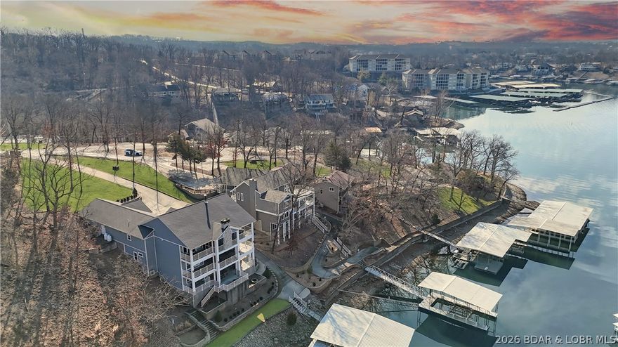 Welcome to 1323 Castle Ct at the 17 Mile Marker here at Lake of the Ozarks This waterfront retreat offers 100 feet of shoreline, deep water, a coveted cove setting & main channel views. Fully renovated from top to bottom, this home is designed for sunsets, lake days & relaxation. A stunning floor-to-ceiling fireplace, open-concept kitchen & dining area w/inviting bar area that flow seamlessly toward the water. A spiral staircase leads to loft overlooking the main living area, perfect for morning coffee, lake views, or golden-hour light. Bedroom levels offer private, serene retreats, including a stunning primary suite with a spa-inspired lakeside bathroom. Addtn'l guest suites & spacious bunk-style room for hosting. The lower entertainment level opens directly outdoors, steps from your private dock & effortless waterfront living. A rare opportunity awaits: seller is offering a $75,000 furnishings allowance & chance to collaborate with an interior designer to complete the home’s furnishings. A curated look book is available, with selections fully customizable. More than a home this is a lifestyle of sunsets, boating & entertaining, Schedule your showing today.