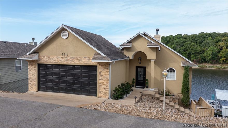 Discover lakeside luxury at its finest with this incredible 4-bedroom, 3.5-bath estate located at the highly sought-after 19MM between Porto Cima and The Villages. You’ll be captivated by soaring vaulted ceilings and an expansive wall of windows framing breathtaking views. The open-concept main level flows into the beautifully updated kitchen featuring granite countertops and ample space for entertaining.  Enjoy two lakeside primary suites, with bedrooms thoughtfully placed across all three levels. Embrace outdoor living year-round with multiple lakeside decks showcasing sweeping water views and a spacious screened-in porch—perfect for morning coffee and evening sunsets. Professionally landscaped grounds offer a gentle walkway leading to a large concrete 3-well dock.  All furnishings are included, making this an effortless, move-in ready retreat. Recent upgrades add value, including luxury vinyl plank flooring, refreshed tile and grout, new interior wood steps, and expanded parking for 5+ vehicles in addition to the attached 2-car garage. Relaxed luxury near popular dining and entertainment—an exceptional lakefront estate ready for you to enjoy from day one.