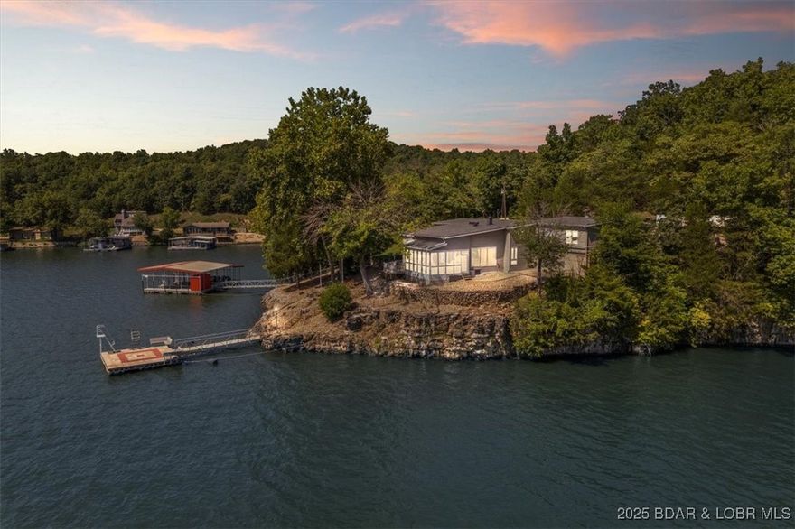 Lakefront Retreat with 400+ Feet of Shoreline with 2 Private Docks
Discover this stunning 4-bedroom, 3-bath lakefront home featuring over 400 feet of pristine shoreline in a coveted cove location with breathtaking main channel views. Designed for lake living, the property includes a 3-car garage, a 2-well dock with PWC slip, 2 PWC lifts, and a separate swim dock for endless waterfront enjoyment.
Step outside and refresh in the outdoor shower after a day on the water, or relax on the expansive lakeside deck while taking in the panoramic views. Inside, you’ll find spacious living areas perfect for gathering with family and friends.
Currently operating as a successful short-term rental, this fully furnished home is ready to generate income from from day one. This home offers a strong rental history and the opportunity to generate income when you’re not here. Whether you’re looking for a full-time residence, a vacation getaway, or an investment property, this lakefront retreat checks every box.
Be sure to check out the Vacation Rental Packet.