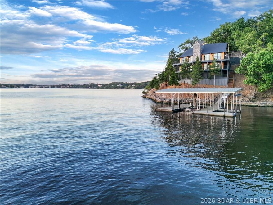 Experience lake living like never before at 1479 Cedar Village — a one-of-a-kind retreat that perfectly blends modern luxury with the beauty of the Ozarks. This home has been completely transformed from the ground up, offering 4 spacious bedrooms, 4.5 baths, and over 2,000 sq ft of deck space to take in those jaw-dropping 8-mile lake views of the main channel. Inside, you’ll find a warm and inviting layout with custom cabinetry, beautiful quartz countertops, and grotto-style showers that add a touch of luxury. The wraparound decks and large entertainment area are made for gathering with friends and family — whether it’s morning coffee with the sunrise or evening sunsets over the water. Plus, there’s plenty of parking for guests, and the thoughtful design makes hosting effortless. Being tucked right in the heart of Osage Beach, you’re just minutes from all the best restaurants, shopping, and lake fun, yet the setting feels peaceful and private. Whether you’re looking for a full-time home or the ultimate getaway, this property offers the perfect mix of comfort, style, and lakefront magic.
