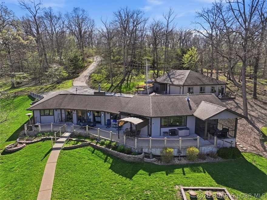 Ranch Style Lakefront Home with 300ft of Shoreline, 1.5 Acres, & Detached Shop w/ Studio Apartment! From vaulted ceilings to tons of outdoor patio space and an outstanding lake view, this is truly a rare find! Walk in to an open layout and vaulted ceiling over the updated kitchen featuring gorgeous counters and lots of pantry space, dining area lakeside, and living room with a gas fireplace. One side of the home has two bedrooms with a jack n jill bath and the other wing is the primary suite with a walk in closet, walk in shower, see through gas fireplace, and walks out to the screened patio area. The detached shop is not only a fantastic workshop area with tons of attic storage space but also has a full bath and kitchenette in the apartment area! Plus, there is a a whole house generator for peace of mind. This lot is so gentle that the walk to the dock is nice stroll on the sidewalk and the entire yard is usable space for pets, kids, and enjoying! 2 boat slips, 2 PWC slips, and a bunch of hangout space on the dock! Sandy beach along the shoreline and this area is great for fishing, swimming and all the water sports. High speed fiber optic internet is available!