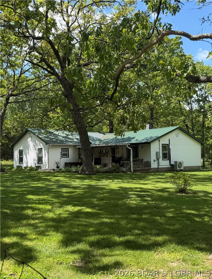 Move-in ready country home on 19.38 acres in Hickory County, Missouri! This updated 3 bedroom, 2 bath home features major improvements including new windows, new roof, updated wiring, and a new septic system, giving buyers peace of mind and modern comfort.
The property offers a great mix of fenced pasture and wooded acreage, perfect for livestock, recreation, and wildlife. A beautiful spring-fed pond stocked with fish adds to the charm and provides a great place to relax or enjoy fishing.

Outbuildings include a 2-car detached garage with workbench and storage area, a large pole barn for equipment and hay storage, plus a well house with an additional storage shed.

This property is ideal for a hobby farm or anyone wanting to enjoy country living at its best with plenty of room for animals, equipment, and outdoor activities.