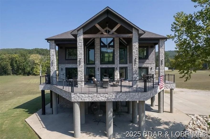 Experience unmatched riverfront luxury at this architect-designed custom cabin on the pristine Current River. Set on 3.77± private acres, this striking retreat combines stone, timber, and expansive glass to capture panoramic water views from every angle. Elevated on reinforced concrete piers, the home offers both secure riverfront living and a commanding vantage point overlooking one of Missouri’s most sought-after waterways. Inside, you’ll find soaring cathedral ceilings, dramatic floor-to-ceiling windows, and an open-concept layout that fills the home with natural light. The grand living area showcases a massive stacked-stone fireplace, premium finishes, and seamless flow into a modern chef’s kitchen and spacious dining area perfect for entertaining guests. Wake up to unobstructed Current River views from the private primary suite, and enjoy the ultimate outdoor lifestyle on the expansive wraparound deck. Whether you’re searching for a luxury full-time residence, a high-end vacation home, or a top-tier short-term rental investment, this exceptional property offers a rare opportunity to own prime Missouri riverfront real estate in beautiful Van Buren. 2262 Brown Rd. Van Buren, MO