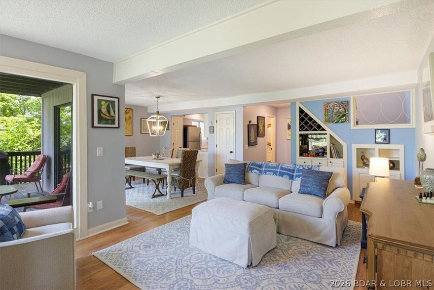 Enjoy lakefront living in this charming, well-established complex with only 3 units—offering privacy and a peaceful setting. This two-level unit features wood-burning fireplaces in both the living room and master bedroom, an open-concept kitchen, dining, and living area, built-in entertainment center, custom cabinetry, pantry, quartz counters, stainless steal appliances, walk-in closet, and laundry/utility space. Take in stunning views of the 29 MM of the Osage from not one, but two lakefront decks. A 12x32 boat slip with jet ski lifts is included, located right in front of the unit for easy access to the water. The dock is for the owners in this building so it has the "private" feel. DEEP WATER is perfect for year round use and swimming/ fishing off the dock is allowed. Conveniently situated near top restaurants, shopping, and local attractions. Rentals must be a minimum of 6 months. This is GREAT way to enjoy the lake of the ozarks as a vacation getaway or a full time residence! Don't wait schedule as showing today!