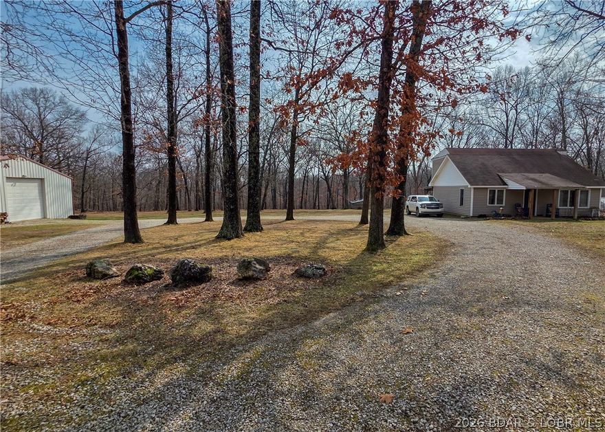 Enjoy peaceful country living on this beautiful 6+ acre property offering plenty of privacy. Step inside the country home featuring a vaulted ceiling with wood beam accents. Large windows create a bright, open area for enjoying family & friends. The home includes a newly updated kitchen with small eat at bar area. All open to dining area that's perfect for family meals and morning coffee. The home offers 3 bedrooms (one currently used as a home office) and 2 bathrooms. One bathroom has a nice corner walk-in shower and one has a full size jetted tub for relaxing & moments of rejuvenation. Walk outside and find a large detached garage/shop complete with a wood stove to keep you warm while working during the colder months. The property is ready for your rural lifestyle with a chicken house, established garden spot already in place and ready for your four legged family members. Expand the entertaining outdoors to the front porch, back covered deck and additional open wood deck. Highway frontage and circle drive all extra conveniences. This is a wonderful opportunity to enjoy space, privacy, and the charm of country living.