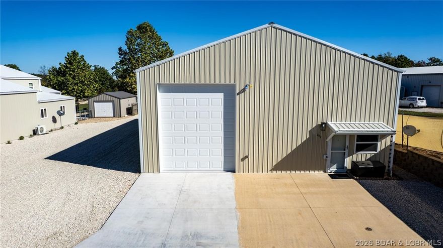 This 40x74 warehouse-style unit offers a rare opportunity in a gated community built for motorhome enthusiasts and toy storage. Designed with flexibility in mind, this space goes beyond a standard building—it already includes a bathroom and an open floor plan, giving you the freedom to customize it into your ideal setup, whether that’s a full kitchen, upstairs and downstairs lounge areas, an office, or any combination that suits your lifestyle. Garage doors are 12x14, 12x14, and 10x10. Off the back of the building, a 14x40' three-seasons room provides the perfect spot to relax, while the private patio extends your living and entertaining space outdoors. An added bonus- this property comes with an additional 12x22' detached garage with electric and window A/C that can be used as additional storage or turn it into a personal gym! With blacktop roads, city water, city sewer, and natural gas, the complex offers both convenience and comfort. Plus, with a public boat ramp located just two miles away, this property is an excellent choice for boat storage or lake access. Other owners have transformed their units into one-of-a-kind showpieces—now it’s your turn to make this space your own.