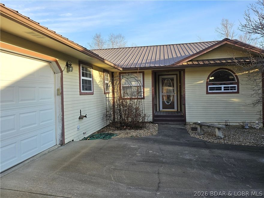 This lakefront homes has many pluses: one level living, attached garage, gentle roadside & lakeside yards, fenced lakeside yard that's great for kids & pets, screened sun room on lakeside with unique window panels that you can either pull up or push down to completely close the room for protection from the weather or have the breeze flow just from the top or bottom, beautiful oak Bella hardwood floors, granite countertops in kitchen with plenty of counter space and cabinets, huge pantry in hall, a beautiful custom window above the kitchen sink for a view outside, a wood burning stove in the living room. Home has 3 bedrooms with a 4th non-conforming bedroom (could also be used as bonus room or an office or play room.  There are 2 and a half bathrooms.  The laundry room has a huge storage closet with a partial closet rod to hang clothes from the dryer.  The laundry room has a half bath plus an additional small sink. The door in the laundry room leads into the attached garage. You don't want to miss checking this one out.  There is a 2-well dock at the property, currently has no electricity to the dock.  Water is shallow in winter but a great place to play in the water in the summer.