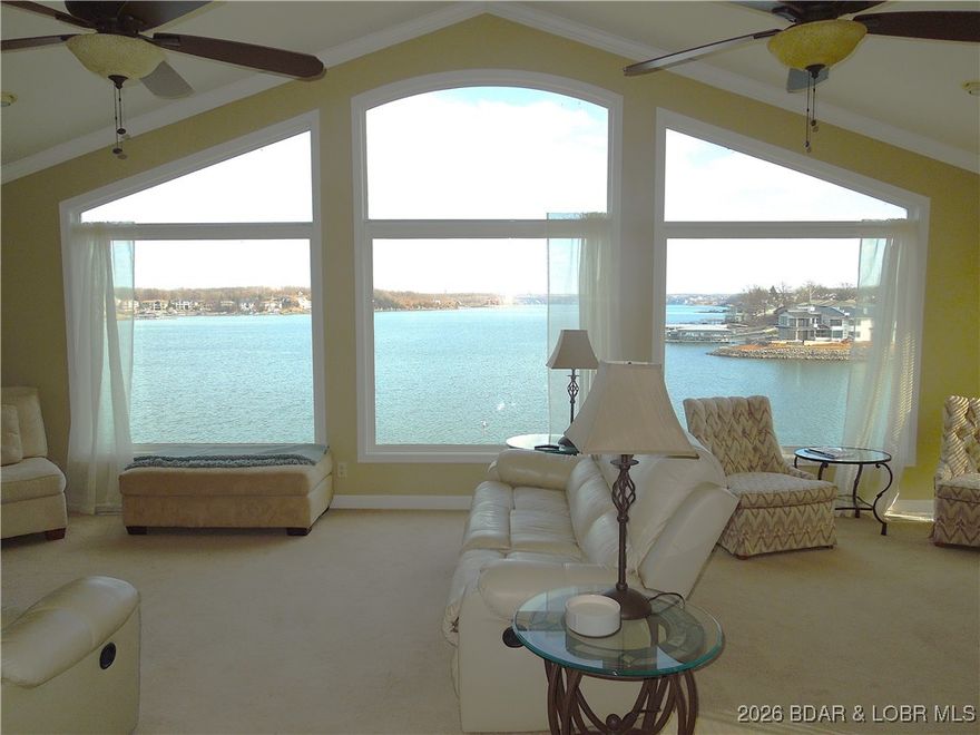 Come make this beautiful home yours & enjoy lakefront living at it's best! This 5 bedroom home offers breathtaking lake views & a warm, inviting atmosphere that was thoughtfully remodeled with modern comfort & timeless charm. Nestled in the heart of Osage Beach this home is just minutes by car or water to shopping, restaurants, entertainment, hospital & more! Enjoy 2 levels with large windows bringing in natural light & frame the stunning Lake of the Ozarks backdrop. The main level includes the primary suite, dining room, kitchen, great room, guest bath & bedroom. The garage was converted to guest bedroom to accommodate their growing family, but can be converted back to a garage. The lower level is ready for entertaining with a family/game room, large decks along with a full bar, three bedrooms & full bath. The restored boathouse is perfect for all your water toys along with a huge deck above. A $75,000 wave break is a bonus to the big concrete dock with a 12x32 foot boat slip which can be extended, a 10,000 lb. poly lift, two wave runner slips with lifts, large swim platform & easy steps in & out of the water. The lakeside yard is nicely fenced for your fur babies enjoyment too!