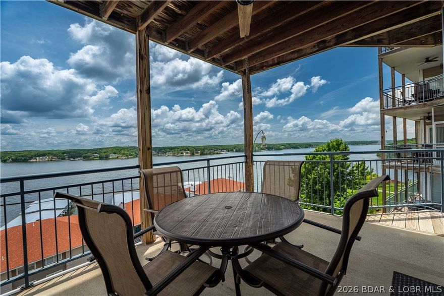 VIEW VIEW VIEW.... Enjoy lake view for miles and miles at the 14 Mile Marker situated atop the desirable Palisades Condominiums. With minimal steps down to the unit, this condo offers a spacious open floor plan with lots of natural light and a large walk out deck. The unit has been updated with new stainless steel kitchen appliances. The Palisades offers some of the best amenities at the lake, including 3 pools, a clubhouse, and a beautiful boardwalk right along the lake, perfect for evening walks. Palisades is located in a gated community, offering security and privacy with easy access by both land and water. This condo is move-in ready and close to everything, including the Bagnell Dam Strip, just minutes from restaurants, shopping, and entertainment. The unit comes fully furnished with a 12x32 boat slip ready for your enjoyment.