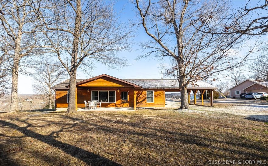 Beautifully updated 3-bedroom, 2-bath log home full of charm and modern touches. Remodeled in 2021, this property features new LVP flooring, new carpet, newer stainless steel appliances including a gas range, custom kitchen cabinets, granite countertops, and updated bathrooms. The primary suite offers a walk-in shower, new vanity, and additional updated fixtures. Natural gas services the property, not propane, adding extra convenience and efficiency. Situated on approximately .67 +/- acres, this corner lot offers ample outdoor space and room to build a garage or shop. Relax on the covered rear deck and enjoy the lake view, or take advantage of the subdivision amenities including lake access via the community boat ramp. Additional recent improvements include a new water heater in 2024 and a new HVAC system in 2025. This is a great opportunity to enjoy lake area living in a beautifully updated home.