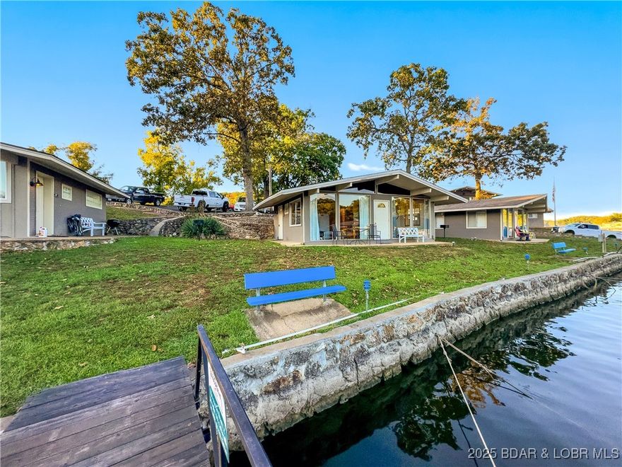 BASS POINT RESORT Lake Cabin with a Dock Slip.  Great Rental History and comes Turn-Key ready to enjoy.  All the benefits to owning your Lake Home.  Close to the Community Pool, 2 Bedroom/1 Bath, Vaulted Ceilings, Laminate Flooring in Bedrooms, lots of Lake View Windows and a Lake Front Patio to enjoy the Lake.  Easy walk to the Dock Slip & community lakefront.  Amenities include Laundry Facilities, Club House with Rec Room for gatherings, Arcade, 2 Pools (1 indoor & 1 outdoor), Tennis, Pickleball & Basketball Courts, Playground, Swim Dock, Boat Ramp, outside Fire Pits and much more. Home is on a successful Rental Program for extra income.  Classic "Lake Cabin" less expensive than a Condo & doesn't have the high HOA fees.