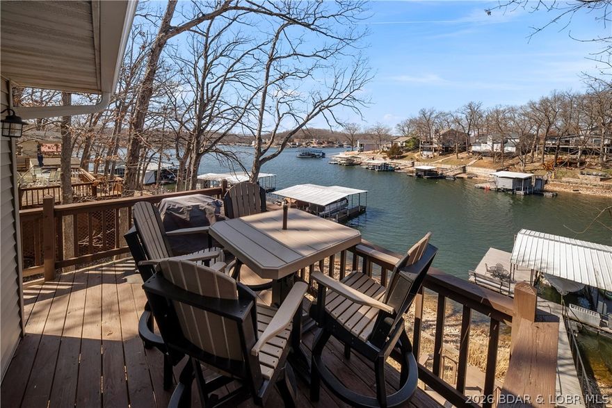 Fun location! Adorable lake house! Lots of outdoor space! This one is made for long lake weekends & drinks at sunset- the kind of property you've been waiting for with a great price point. Perfectly positioned at the 7 Mile Marker directly across from Shady Gators & Camden on the Lake, updated home is in a protected cove with 4 bedrooms, 2 full bath. This location puts you right in the middle of the action while still giving your own cozy lake escape. Inside it is bright, cheerful & tastefully decorated with lakeside windows letting the views pour in. Another big win- pavement all the way to the door so no winding gravel roads to deal with. Outside is where this place shines with a wraparound deck, firepit, martini deck & walkout basement leading straight to your private dock. So easy to jump between boating, swimming & relaxing. When you’re ready to head out, you’re just minutes from Tap & Grill & the new Buck Creek Marina. And if you’re thinking investment, this home already has rental history, giving you opportunity to enjoy it yourself while it helps pay for the fun. This home has that effortless “kick off your shoes & stay awhile” lake vibe everyone is looking for! Call today