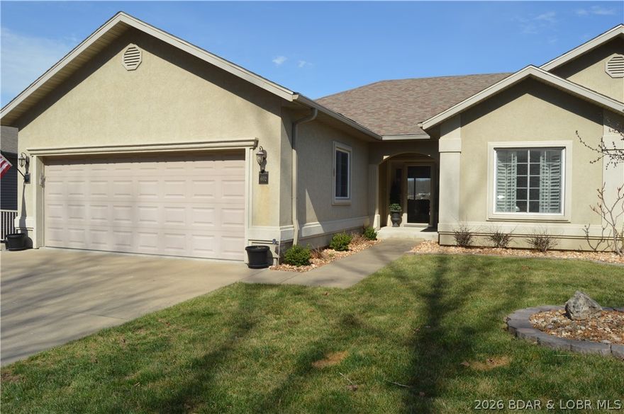 The comfort and space of a waterfront home without the price! You won't find a better value with 5 bedrooms (1 non-conforming), 3 covered decks (1 screened), 2-car garage and great cove location! This villa has been meticulously cared for with numerous upgrades  including light and bright granite and backsplash in kitchen, fresh paint and carpet upstairs, new roof, custom stone fireplace, and a unique 800 sf workshop/mancave. Located conveniently on the 3 mile mark by water and only minutes from Bagnell Dam and HWY 54 giving easy access to restaurants, retail shops and fun lake entertainment complexes. This small upscale project provides a private fun environment in a deep no wake cove--perfect for kayaking, paddleboarding or just hanging out on the small community dock --just steps from your lower deck. Living is easy at Waterfrord Landing with community pool and exterior maintenance covered by the HOA giving you more time for YOU! With 3,148 sf there is room for everyone--4 bedrooms plus bonus room, 4 full baths, 2 large living areas, 3 covered decks,  workshop, and more storage than most homes. 14x36 Slip and 2 PWC spaces just steps away. Schedule your private tour today!