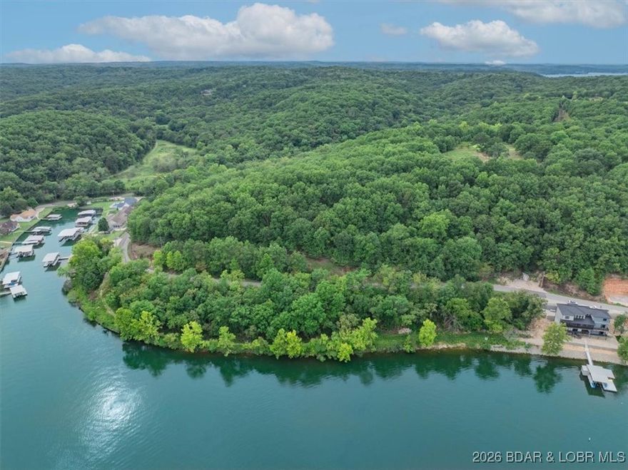 This Lot and its Accessory Lot are just what you have been searching for!  The Laurie Hollow Cove Location is one of the best areas on the West Side with deep water and spectacular views.  The Water and Sewer Treatment System are already there and Electricity is at the Pole on an Asphalt Road. This is a can't miss opportunity to own a spectacular Location with an incredible Builder.  Please ask about the Custom Homes this Builder can build on this Lot, you will be amazed with the Quality of the Home without a doubt!