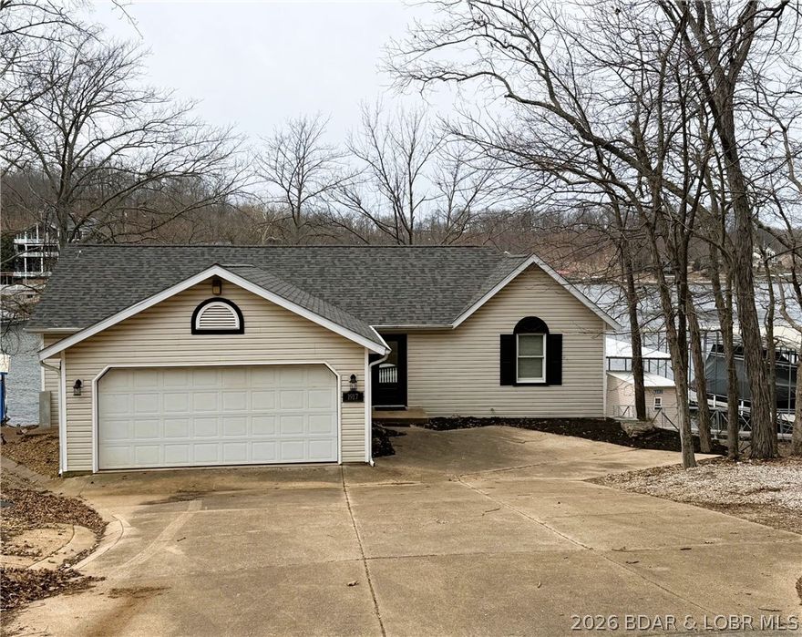 Experience exceptional lakefront living in this beautifully updated home in the heart of Osage Beach at the coveted 22-mile marker. Properties with a rare 4-well dock in this location are extremely hard to find, making this a standout opportunity for serious lake buyers. Offering 4 bedrooms and 4 baths, the home features an open-concept design that flows effortlessly between the kitchen, dining, and living spaces—perfect for entertaining after a day on the water. Enjoy cozy evenings by the wood-burning fireplace and breathtaking lake views from the brand-new deck. Major updates include a new roof, new front door, new lights, fresh paint, and new deck, giving the home a fresh, move-in-ready feel. The property is being sold fully furnished, allowing you to start enjoying lake life immediately. Step down to your private dock with hoists for boating, swimming, and fishing right from your shoreline. With location, updates, and a 4-well dock, opportunities like this are rare—schedule your showing before it’s gone.