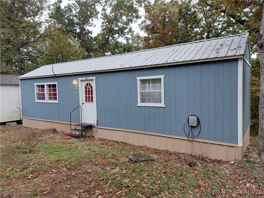 Move in ready! Well maintained 1 bedroom, 1 full bath Tiny Home waiting for you! New ductless MiniSplit installed in 2025 for economical heating and cooling! All appliances included-range, refrigerator, dishwasher, washer, dryer, small freezer. Furniture- table and chairs, two living room chairs, small TV with antenna, small desk and queen size bed. High speed fiber optic internet ready to be connected. What you see is what you get! Store your excess items in the small storage shed that is included. Community water is paid up through September, 2026 so no water fees until then! Private septic installed in 2021. Property was surveyed in 2021 and copies are available. Not often do you find a Tiny Home with a dedicated bedroom and dedicated full bathroom with tub and shower! Make this your home or investment property with no rental restrictions!