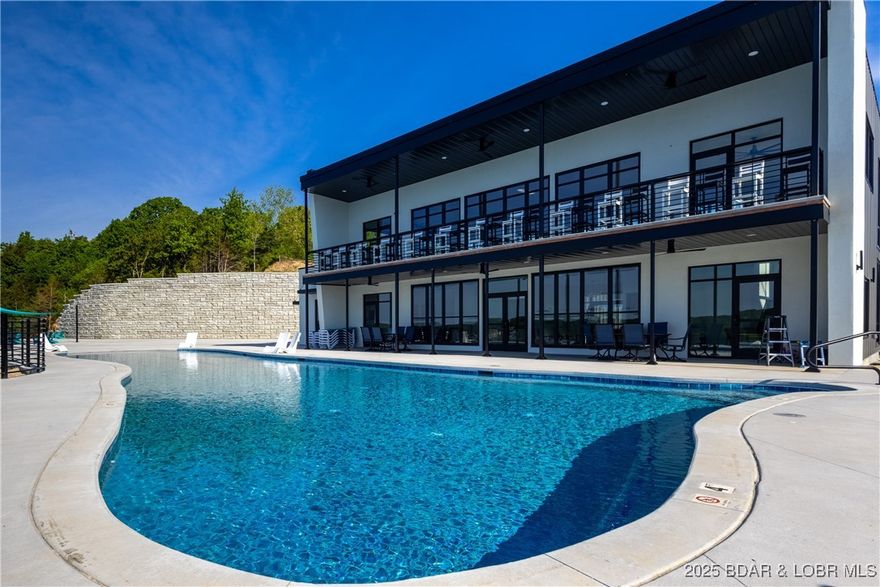 The Toy Box is located at the Lake of the Ozarks most recognized intersection at Horseshoe Bend and Bagnell Dam Blvd. in Lake Ozark, Missouri. With a 180 degree Panoramic View of Lake of the Ozarks, these Lux Loft units are like nothing else in the area. Each unit is (25’ x 60’ with 23’ side walls and a mezzanine) for Residential use only. The development will be governed by a Condo Owner Association and will include a pool, clubhouse with full indoor kitchen, innovative gym, outdoor grilling area and pickle-ball courts. A boat wash area and RV pump out allow you to work and play within your own community. An observation deck with fire pit overlooking miles of Lake of the Ozarks shoreline truly set this property apart from all others, while giving you the peace of mind of a gated community! All of this just a minute drive from the buzzing Bagnell Dam Strip. Come be a part of the Lake of the Ozarks where We Have a Lifestyle For You!