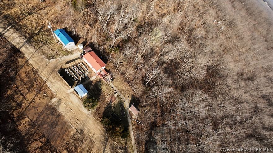 Escape to 9 acres of country living, just 0.2 miles down a gravel road from Highway 135! This property is set up for off-grid living and currently features a tiny home perfect for those who want to channel their inner minimalist and experience the great outdoors without the distractions of modern life. You’ll find a large garden space ready to flourish, complete with a low-pressure water system designed for off-grid living. It’s like having your own mini farm, and just think of the Instagram posts you can share while pretending to be a homesteading pro! This blank canvas is just 2 miles from Ozark International Raceway and 20 minutes from the Loop 2 Lake Ozark Off-Road Park, making it an ideal spot for development near major attractions. Plus, with access from two gravel roads, this property could easily be split or developed into multiple lots perfect for building vacation rentals, a community, or whatever your heart desires! With no restrictions, you can let your imagination run wild. Don’t miss this unique opportunity to embrace country living and capitalize on the nearby raceway and off-road park! Broker Owned