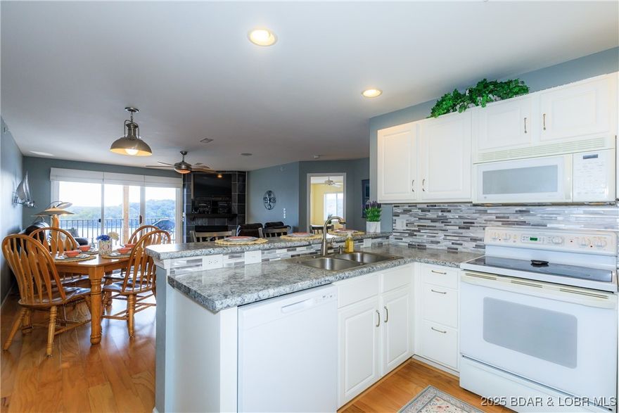 This is the VIEW everyone is looking for.  Unobstructed, open and inviting.  No other complex is nestled within the state park and gazes at state park on the other side of the lake.  If you crave the quieter area of lake life, look no further.  This one is just waiting for you to sit down and put your feet up.  Located on the Grand Glaize Arm of the Lake of the Ozarks, this 3 br 2 bath condo was made for fun times.  A 12x30 boat slip with hoist and remote is included and can be accessed via elevator in the bldg next door. Community pool, clubhouse, playground, firepit area and a lot of green space can be enjoyed.  Only 10 miles back to multiple shopping/eating establishments without all the traffic hassles.  The stress of everyday life will fade away as you cruise back to your new lake escape.  Enjoy the changing seasonal views.  Deer, turkey, and turtles may be seen on your drive.   This unit has not been rented but could be if you so desire.  Dreams to Reality!  Call TODAY!