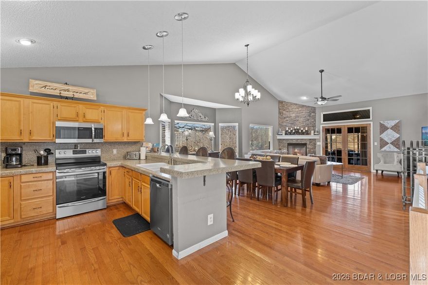 Location. Luxury. Lifestyle. This exceptional waterfront retreat truly has it all. A new roof, rich hardwood floors, and granite countertops, the home showcases an impressive open-concept design anchored by a stunning stone fireplace. Seamless indoor-outdoor living continues into the 3 season deck, where main channel views create the perfect backdrop. Enjoy zero-step entry and an attached two-stall garage offering easy functionality. The primary suite on the main level, complete with laundry, delivers effortless single-level living. Downstairs, the expansive family room features a pool table, a lively tiki bar, and direct access just steps to your massive dock. Set in a protected cove with deep water year-round, this property is ideal for swimming, paddleboarding, kayaking, and soaking up endless lake days. Margaritaville is just across the cove placing dining and entertainment at your fingertips. Centrally located by both land and water, with easy access to premier attractions, shopping, and Lake Regional Hospital. Whether you’re seeking a full-time residence, a vacation escape, or an investment, this property delivers on every level. This is lake living at its absolute finest.