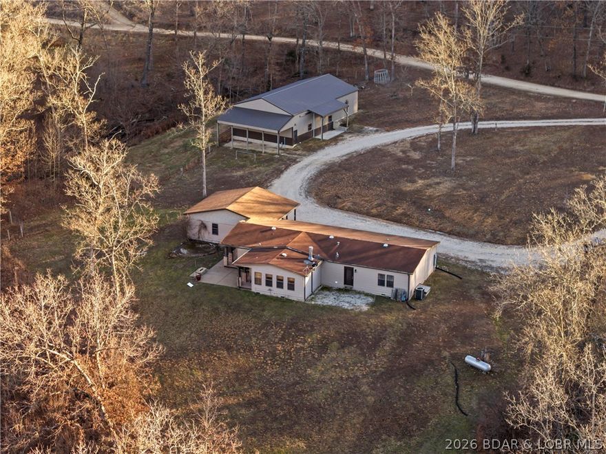 Beautiful 3 bedroom 2 bath home on 15 acres close to town. Attached oversized garage. Fenced and crossfenced with a creek. This home is suited for equestrian use or hobby farm. Impressive 33x70 shop/barn with
lean-to on side and rear, perfect for equipment, livestock, or workshop space. Open kitchen with with center
island is a chef's delight. Master bedroom en-suite bathroom with walk-in shower and soaking tub. Country
charm, functionality, and convenience all in one Lake of the Ozarks property. Assumable 165K loan at
approximately 3.75% at the time of listing