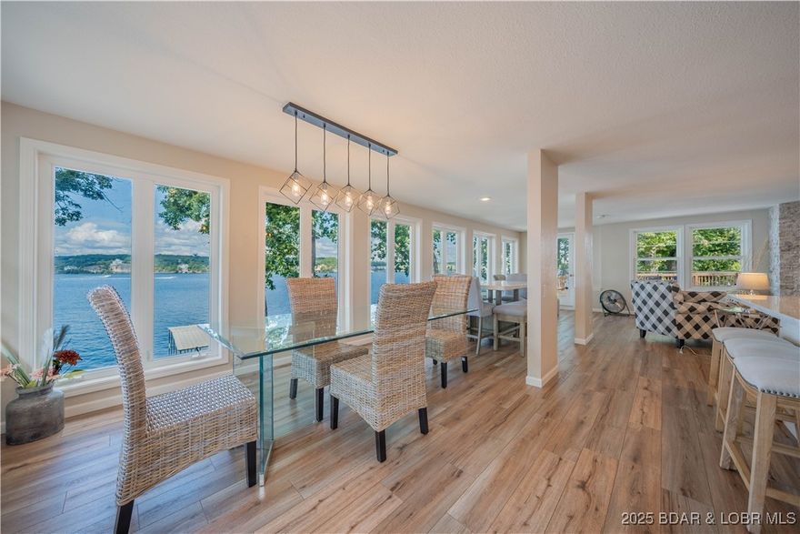 Incredible Lakefront Investment Package — Two Updated Homes, Turn-Key & Income-Producing with $240k grossed in 14 months. This exceptional setup includes a 4-bedroom home and a 5-bedroom home, both thoughtfully updated with quartz countertops, durable LVP flooring, and stylish finishes throughout. Each property comes turn-key, fully furnished with décor, kitchenware, and everything you need to start enjoying or renting out immediately. Currently, these adjacent homes comfortably sleep a combined 30 guests, making them ideal for vacation rentals.  Outside, the property features a private dock with a 36’ slip and PWC slips, perfect for making the most of Lake life. The flat double lot offers plenty of room for outdoor fun and easy access to the water, all while taking in the huge main channel views. Both homes come fully furnished and equipped, allowing for a seamless transition into ownership. Imagine the possibilities: keep both homes as high-demand vacation rentals, create a family compound, or explore options for long-term rentals. The choice is yours!