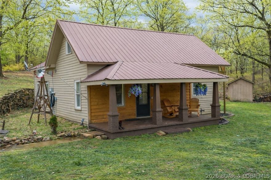 Charming renovated 3 bed, 2 bath farmhouse on over 3 acres offering the perfect blend of country charm and in-town convenience! The scenic property features a mix of open and wooded areas with a small creek running through the land, creating a peaceful and inviting setting just blocks from everything you need in town and only about 15 minutes from Lake Ozark.

Inside, the home has been refreshed with new LVP flooring through the living area, kitchen, and bathrooms, along with fresh paint throughout. The upper level offers a huge bedroom retreat with its own private exterior entrance and deck, providing flexible space for a third bedroom, children's playroom or office.

The property also includes a second home ready for renovation, offering excellent potential for independent living for family or as a rental opportunity. Additional features include two garages with shop space, multiple outbuildings, a smoker, fire pit, and chicken coop.

With nearly 3.5 acres, versatile buildings, and a charming farmhouse feel, this property offers space, character, and endless possibilities in a convenient location.