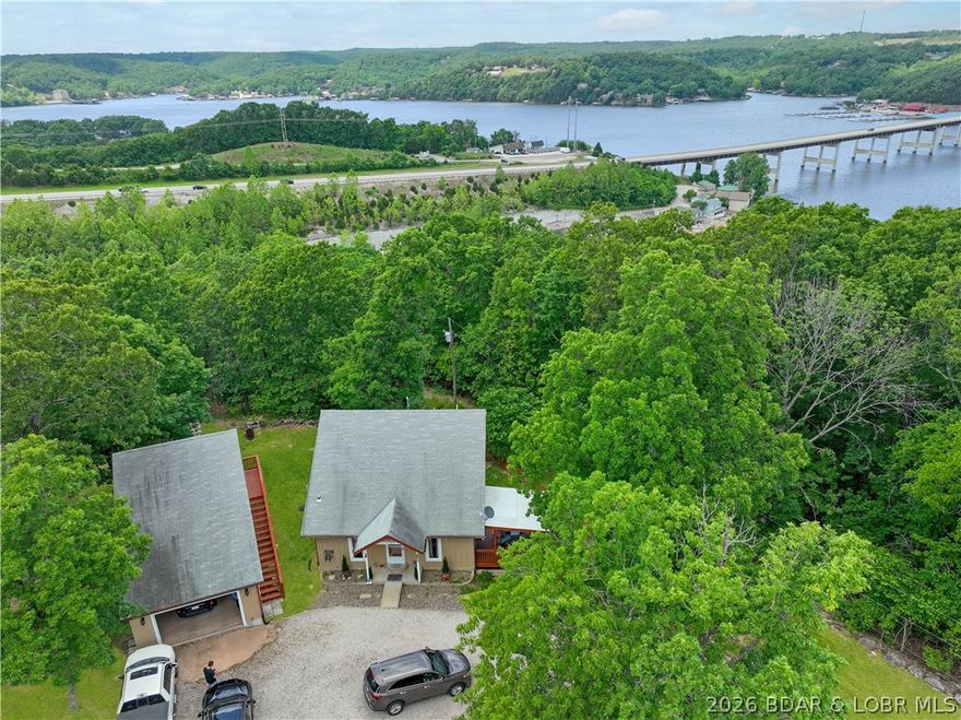 Here's a new listing at 107 View Dr. in the Niangua View Subdivision of Camdenton. This well-maintained home on a gentle one-third acre lot offers a quiet atmosphere and a seasonal lake view, located just five minutes from a boat launch!  The main floor features a comfortable living room with vaulted ceilings and wood floors, a large eat-in kitchen, and a primary bedroom with extensive built-ins and easy access to the laundry and a bathroom with a new flooring and a walk-in shower. Pantry storage under the stairs is also a plus.  Upstairs, you will find a loft bedroom and a large full bathroom.  Bonus Space: A 16x18 heated and cooled room above the garage, perfect for a third bedroom, office, or game room.
- Garage & Storage: A heated and cooled 1+ garage with a workshop area, plus a separate storage shed with stylish barn doors.
- Outdoor Living: A covered deck and a newer wood-fenced yard, ideal for children or pets.
 New septic laterals and the seller has done several things like new water heater, new anti-freeze exterior faucets, new carpet.  Its ready for you to enjoy! 
The subdivision has a community dock.  Seller is checking to see if any slips would be available.