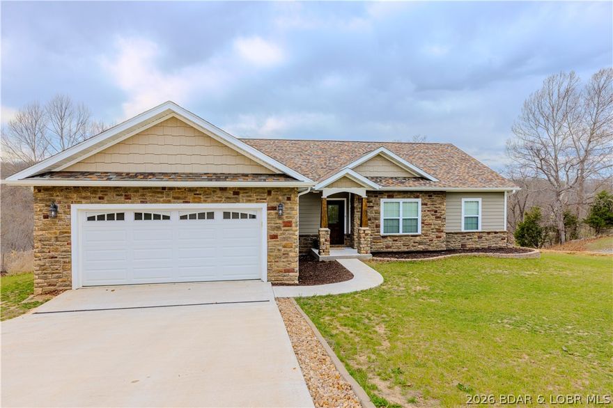 This beautifully built 4-bedroom, 2.5-bath home located in the desirable Buckingham Estates community. Newly built in 2024 sits on a spacious corner lot. Step inside to an open and inviting layout featuring luxury vinyl flooring throughout, upgraded maple soft-close cabinetry, granite countertops, and a stunning kitchen island with stone accents. The kitchen is complete with stainless steel appliances and flows seamlessly into the main living and dining areas which is perfect for entertaining. The spacious primary suite offers a large walk-in closet and a custom walk-in shower designed with comfort and style in mind. Three additional bedrooms provide flexibility for guests, family, or a home office. Enjoy outdoor living on the covered deck with trex flooring, ideal for relaxing or entertaining. Excellent community amenities including multiple pools, clubhouses, tennis courts, and lake access with community dock opportunities making it easy to enjoy everything the lake lifestyle has to offer. This move-in ready home offers modern construction, quality finishes, and a fantastic location just minutes from Camdenton amenities, dining, and shopping.