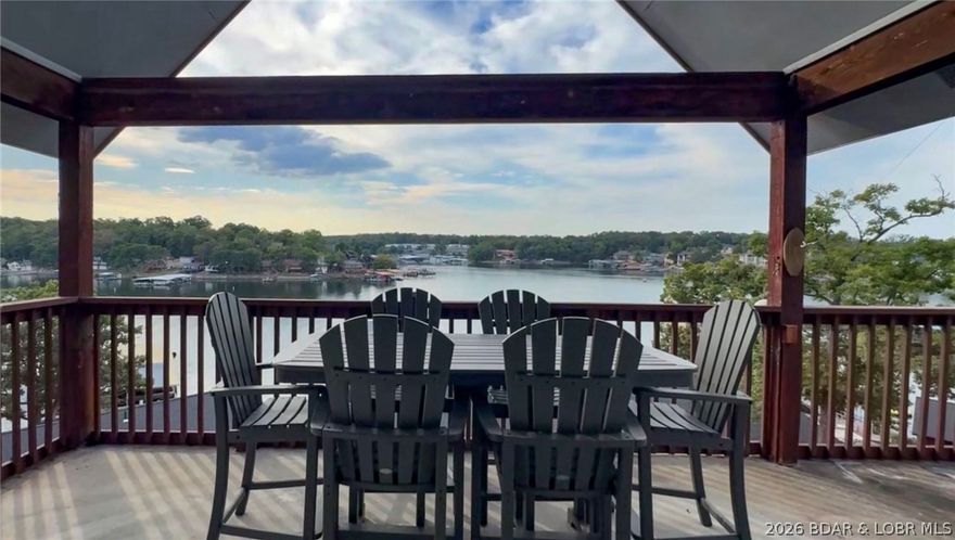 Top-floor living at Summerset Condominiums blends thoughtful updates with classic Lake of the Ozarks charm. With over 2,100 square feet, the main living area features vaulted ceilings, a striking stone fireplace (inoperable), and direct access to the lakeside deck. The kitchen has been refreshed with stainless appliances, solid surface countertops, and bright cabinetry, opening into the dining space. The primary suite offers private deck access and jetted tub, while a guest bedroom and full bath complete the main level. Upstairs, the oversized loft currently serves as the third bedroom with its own full bath and additional storage. The lakeside deck is made for relaxing, with extra storage and an elevated second-tier view that speaks for itself. Offered furnished for immediate enjoyment. Summerset Villas is a boutique 14-unit community featuring a lakeside pool, peaceful cove setting, and welcoming atmosphere. Spend your days on the water, fishing nearby, or take a short walk to Dog Days Bar & Grill. Prefer a night in? The clubhouse offers a full kitchen, conference space, pool table, and more. Boat slip may be leased from Gozark Resort formerly Summerset next door.