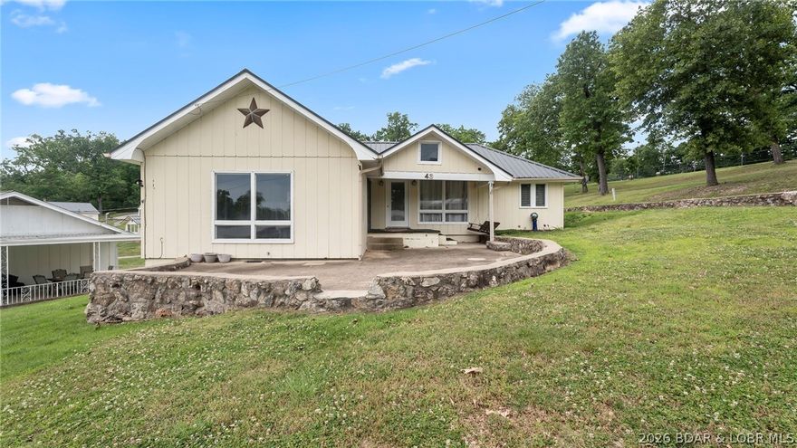 Charming 3-bedroom, 1-bath cabin offering all main-level living and the perfect lake lifestyle! This move-in-ready home features a cozy electric fireplace , creating a warm and inviting space to relax after a day on the water. The community is also developing a golf cart parking area and path, making it even easier to enjoy the neighborhood and waterfront amenities. Included with the property is your own 10x24 boat slip, making lake access easy and convenient. Located at the popular 8 MM in Buck Creek Cove near Shady Gators and Camden on the Lake, you’ll be just minutes from waterfront dining, entertainment, and all the excitement Lake of the Ozarks has to offer. From the road, you are right across from Bear Bottom Resort.  This is a perfect investment opportunity whether you're looking add an additional nightly rental to your portfolio, or for incredible 2nd home living opportunities. Call now to schedule your private showing!