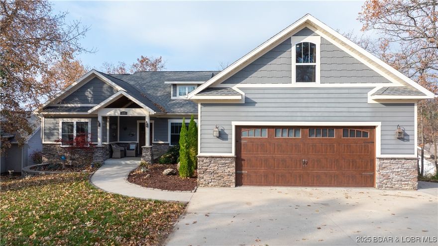 Seasons change & so does the perfect moment to purchase a home. Step into this stunning, 11-year new home offering nearly 4400 sq ft of luxurious living space - featuring 6 generously sized bedrooms, an open & alluring floor plan, & exceptional storage throughout. From the inviting screened-in-deck to the cozy two-way fireplace this home welcomes you w/ well-designed, intentional details. Distressed hardwood floors add timeless character & warmth to the main living areas. A two-car garage is complimented by a 3rd garage space w/ a dedicated golf-cart path offering endless possibilities for storage, workshop, fitness or hobbies. A rare luxury is the flat yard & driveway w/ ample parking. Even better this property includes a 12x32 boat slip, giving you instant access to lake living. All of this in a prime location just minutes from grocery stores, popular restaurants, schools, churches & the iconic Bagnell Dam.  The Estates also has a private pool to soak up the sun & socialize w/ your neighbors. A true must see, this property delivers unbeatable value & space blended with elegant lifestyle. Elevate your everyday & make this moment your perfect time to own this custom crafted home.