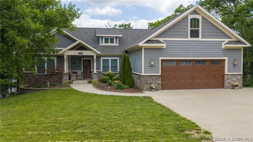 Brand new roof installed May 2026 and a new price that is hard to beat!  This custom Craftsman home is priced at just $163/sq ft - well below todays replacement cost. Enjoy peace of mind knowing this big-ticket update has been completed. This stunning, home offers nearly 4400 sq ft of luxurious living space, featuring 6 generously sized bedrooms, an open & alluring floor plan, & exceptional storage throughout. From the inviting screened-in-deck to the cozy two-way fireplace this home welcomes you w/ well-designed, intentional details. Distressed hardwood floors add timeless character & warmth to the main living areas.  A 3rd lower-level garage space has many possibilities like storage, workshop, fitness or hobbies. A rare luxury is the flat yard & driveway w/ ample parking. Even better this property includes a 12x32 boat slip, giving you instant access to lake living. All of this in a prime location just minutes from grocery stores, popular restaurants, schools, churches & the iconic Bagnell Dam.  The Estates also has a private pool to soak up the sun & socialize w/ your neighbors. If you have been searching for value, quality, & equity then 135 Windjammer delivers!