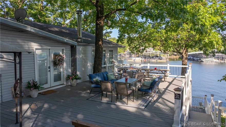 Investment Opportunity Alert!  This outstanding nightly rental located in the heart of Osage Beach on the 20 mile marker has several unique features that make it an excellent rental, but the fact that all 4 bedrooms have a private bathroom &shower within each room is the feature that most renters love. Sure, there's 177' of shoreline & main channel views from the property while still located in a protected cove, over 500 sq. ft. of decks where one can catch an awesome sunset, a 2 well dock with 3 PWC Shore ports, three kayaks, a lily pad, & a swim platform, 8 smart TVs scattered throughout the place & plenty of off-the-street parking, but people always seem to go back to the 4ensuites on that main level. The walkout basement is now a bunkroom and from there, it's a short walk to the dock or the hammock that is near the bottom deck. There are two washer / dryer hookups on the main level should an owner want to have two stackable sets going at the same time and with the propane fueled tankless water heater, there's always hot water. This property is being sold completely turn key & "As Is" & the possibilities with this property are endless.  Come take a look!