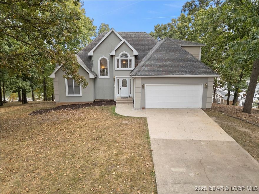 Welcome to this 5 bed/3.5 bath lake view home located in the peaceful & beautifully maintained subdivision of Robyns Point in Osage Beach. Perfectly positioned for convenience, you’ll be within walking distance to Michael’s Steak Chalet & just across the cove from Miller’s Landing Marina/The Hatch Restaurant. Lake life couldn’t be easier with access to a sparkling community pool & your very own 12x28 boat slip on community dock in deep water cove at 28 mile marker. Inside the home, a blank canvas awaits- ready for your personal touch. Home is being sold As-Is. Design your space around the abundant windows that fill the rooms with natural light, cozy fireplace, open layout to maximize space for your family. The kitchen flows seamlessly into the covered upper deck overlooking the 2nd tier tranquil surroundings. Enjoy the ease of daily living with laundry room & large master bedroom ensuite on Main Floor. Downstairs finished basement provides 2nd living room space—ideal for kiddos/guest overflow. Plus bonus room to convert into office or bedroom. This location is hard to beat with its FLAT driveway, 2 car garage- be a wonderful place for full time family to enjoy effortless lake life