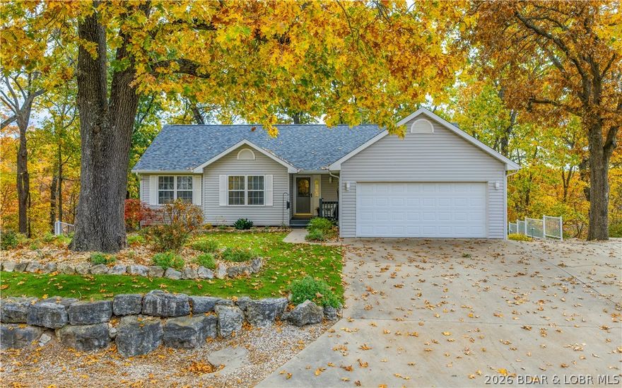 Welcome to 662 Grandview Ln in Linn Creek — a beautifully updated home in the heart of LOTO! Nestled on approximately 3 acres, this 5-bed, 3 bath home offers a blend of seclusion, space, and lake convenience. Step inside to high ceilings, oversized windows, gorgeous lighting, a sound system, and rich hardwood floors that create a warm feel throughout. The living room features a gas fireplace and flows into the kitchen with quartz counters, quality cabinetry, and design details that make everyday living and entertaining effortless. The full finished basement expands your living space with room for guests, recreation, or multi-generational living. Enjoy relaxing on the sun porch or on the covered deck overlooking the beautifully landscaped grounds. Outdoors, you’ll find meticulous attention to detail — an irrigation system, garden beds, lush landscaping, and a firepit. Enjoy access to the community dock with your own slip, making lake days simple. Car enthusiasts and hobbyists will appreciate both the attached and detached garages, plus RV parking. This property checks every box — location, space, updates, and lifestyle. Don’t miss your opportunity to own a slice of paradise at LOTO!