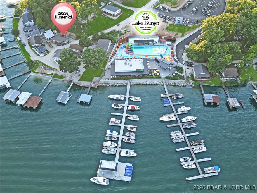 This is your opportunity to own an affordable slice of paradise at the Lake of the Ozarks, complete w/ breathtaking views. Overlooking the 5-mile marker of the Gravois Mills Arm in Mill Cove, this charming 1-bed, 1-bath retreat is the perfect weekend getaway or investment property. Located in the sought-after Cloud Nine subdivision, homeowners enjoy access to a shared beach area to soak up the sun. Just steps from the popular lakefront restaurant, Lake Burger, this home offers the convenience of dining & entertainment within walking distance. Remodeled in 2019, every inch of this home was thoughtfully designed to maximize space & comfort. The welcoming front deck is perfect for summer barbecues, relaxing with friends, or simply taking in the picturesque lake views. For boating enthusiasts, boat slips are available for annual rental just 5 minutes away in Mermaid Cove.