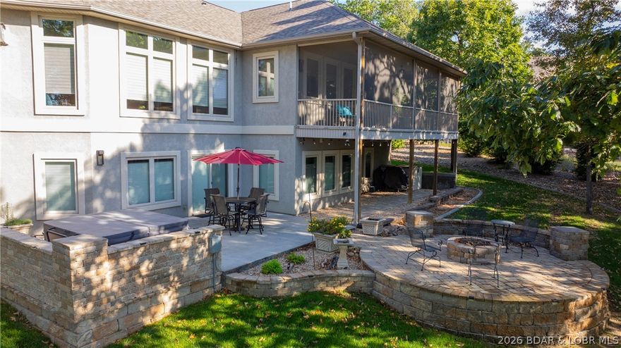 Space where you need it, privacy where you want it, and a layout that makes everyday living feel easy. Set on over ¾ of an acre in the prestigious Villages at Shawnee Bend, this spacious 4 bedroom, 4.5 bath home offers a peaceful setting with lush landscaping, a gentle lot, and a backdrop of sparkling lake views. Inside, natural light fills the open living space, highlighting hand-scraped wood floors, soaring ceilings, 8-foot solid doors, and a stunning stone fireplace. The custom kitchen is designed for gathering, featuring rich alder cabinetry, a stacked stone island, granite countertops, tile backsplash, and stainless appliances. Main-level living includes the primary suite with a spacious bath, along with an office, laundry room, and guest bath. Downstairs, three en suites, a second living area, wet bar, and walkout patio with hot tub create the perfect setup for gathering with family and friends. Start your mornings sipping coffee on the screened deck and unwind in the evenings around the firepit under the stars. With geothermal heating and cooling and a nearby marina with boat slips available, everything is in place to enjoy the lake without giving up the comfort of home.