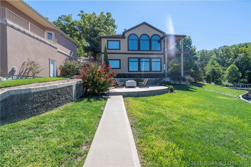 This stunning 5 bedroom, 4.5 bath home is the epitome of luxury Lakefront living with its prime location, breathtaking views, & exquisite finishes located here at Lake of the Ozarks. This gated community located on the westside offers luxury, privacy, views,& a private park like drive into your new Lake home. As you enter the home, your greeted with a wall of windows open living, kitchen dining area that has been set up masterfully for entertaining. Master suite is located just off the main room with soaring ceilings & luxurious bath suite. Tag the fun meter as you enter the lower level where you will find another wall of windows to take in those Lake views. 4 bedrooms, one a private suite, two sharing a bath in the middle and the fourth located down a hall. On this level you will also find a large finished storage room perfect for outdoor toys, cushions, etc. All rooms have been tastefully decorated relaxation & rest. This home is turnkey with virtually no maintenance. Get ready to relax this Summer in this ultimate Lake of the Ozarks luxury pad. Call to schedule your private viewing today.