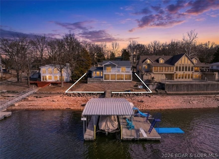 In the heart of Lake of the Ozarks at the 22 mile marker, this meticulously maintained lakefront home delivers an unbeatable land and water location! Located in Woods Hollow Cove with main channel views, it's the best of both worlds with outstanding main channel views and cove protection! The lot is exceptional—flat driveway with parking for 5+ vehicles and an easy walk to the dock! This dock is built for making memories--featuring a slide, high dive, ladder, and huge swim platform that is perfect for entertaining everyone! Outdoor living truly shines here with a partially covered concrete deck, a spacious lakeside sunroom with track windows that open to the breeze, and an additional patio with a fire pit and a grilling area. Inside, the home offers 4 bedrooms (one that walks out to the deck, 2 updated bathrooms, and a living room area on each floor. Recent updates include a new roof in 2025, bathroom remodels, fresh paint, and adding a 1-car garage. Perfect for full-time living, lake getaway, or nightly rental investment! The community boat ramp is just one house over and numerous lakefront favorites like Redhead, High Tide, Paradise, and Margaritaville are close by!